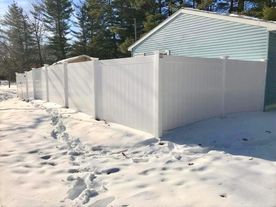 Photo of vinyl fence installation in winter by New Hampshire fence company