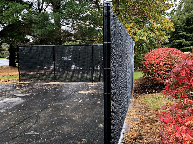 Black chain link fence with privacy slats in Derry, New Hampshire, NH
